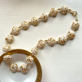 Necklace with white pastel appliqué over gold Murano glass medium lentil beads on gold